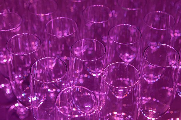 istock empty champagne flutes on a purple background 175390356