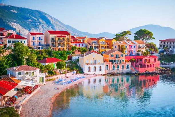 Assos, Kefalonia - Greece. Beautiful picturesque village nestled on the idyllic Ionian islands. Colorful houses and turquoise colored bay.