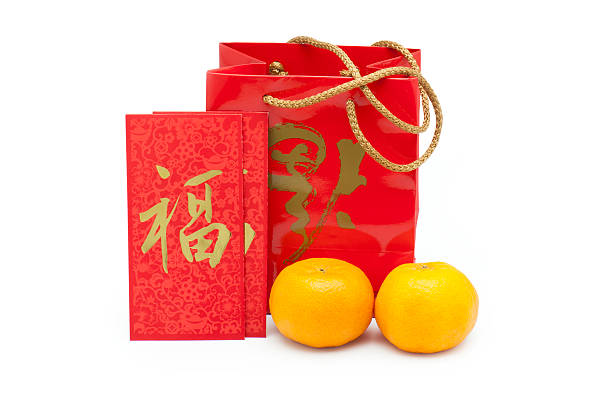 Mandarin orange with carrier bag and red packets stock photo