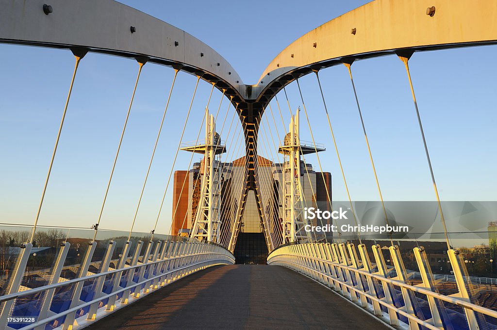 Millennium Bridge, Salford Quays, Manchester Wide angle view looking across the Millennium Bridge in Salford Quays, illuminated by early morning sunlight. Bridge - Built Structure Stock Photo