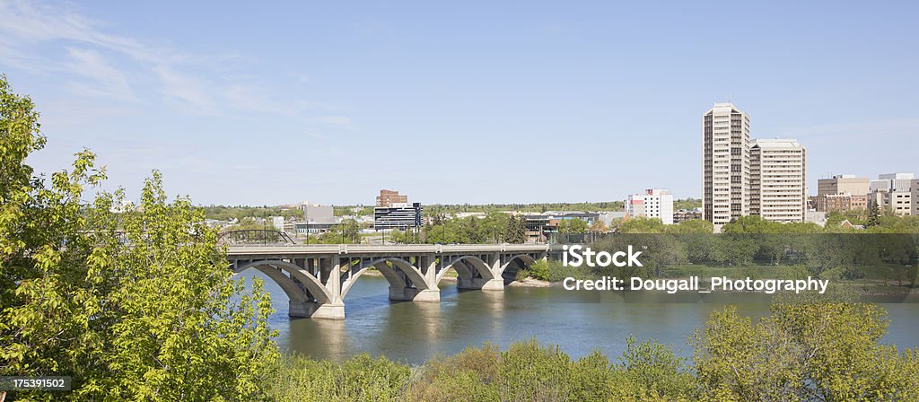 Broadway Bridge Across the South Saskatchewan River in Downtown Saskatoon Panoramic image of Broadway Bridge across the South Saskatchewan River in downtown Saskatoon.  High rise apartments and hotels can be seen on the other side of the river. Apartment Stock Photo