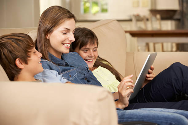 istock Mother And Two Children Sitting On Sofa At Home 175392293
