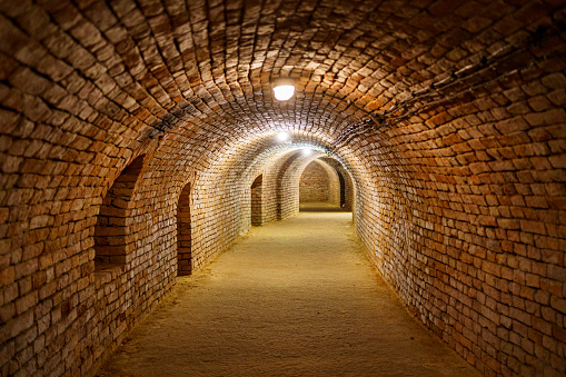 Brick-lined corridor with loess floor in old underground cellar