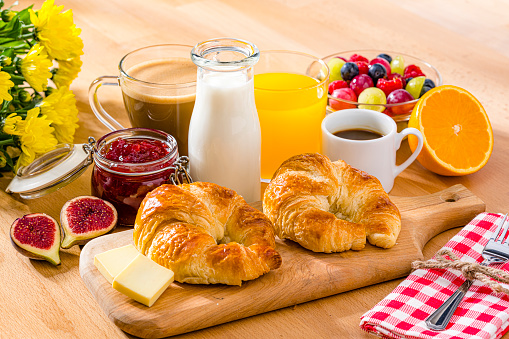 French breakfast. Croissants, jam, coffee, orange juice and fruits