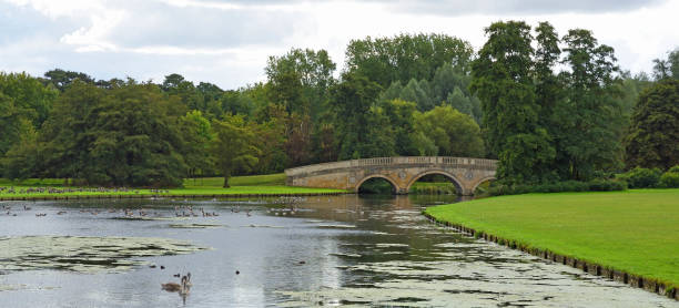 istock Ornimental lake and bridge with trees in background. 1753930210