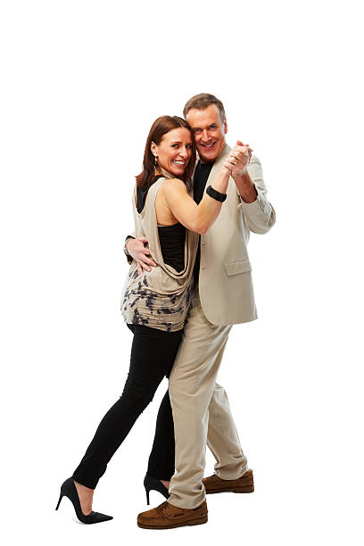 Happy mature couple in love dancing over white Portrait of happy mature couple in love dancing over white background middle aged couple dancing stock pictures, royalty-free photos & images