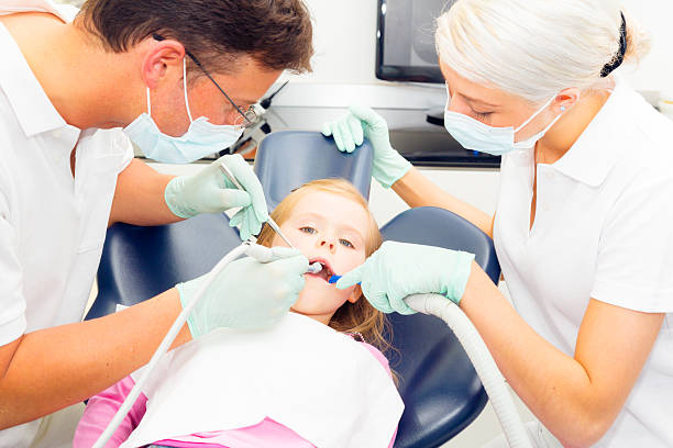 istock little girl seeing her dentist 175393412