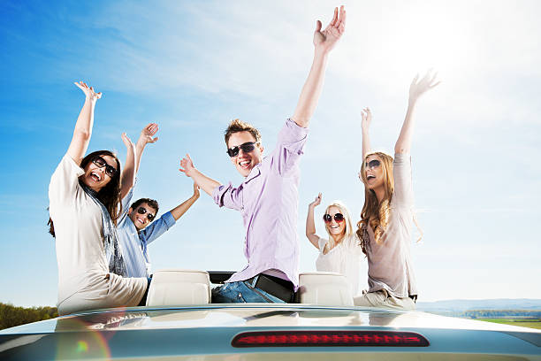 istock Group of young people sitting on a Convertible car. 175393428