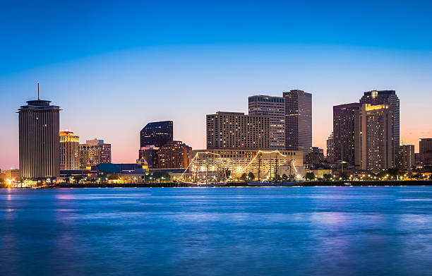 New Orleans skyline looking across the Mississippi River at sunset.