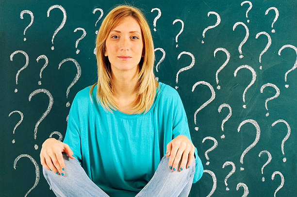istock Pensive Woman in front of Question Marks 175393637