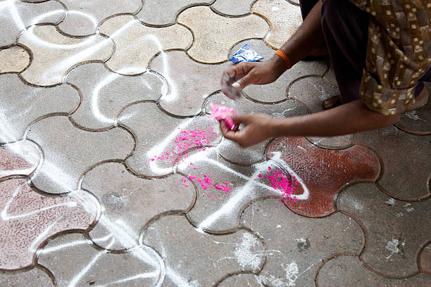 Street artist using pink powder paint
