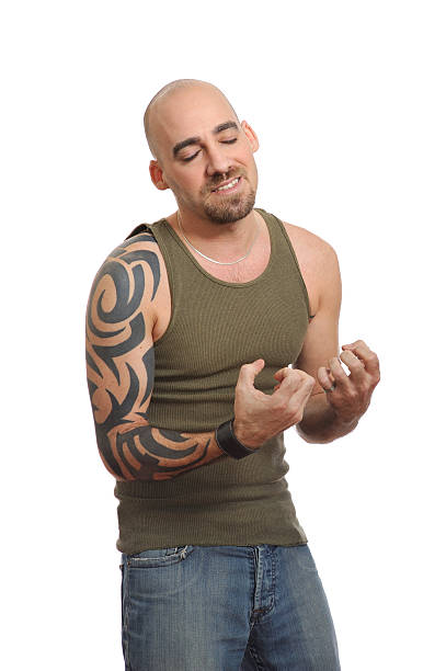 istock Tattooed man with shaved head showing emotion 175394712