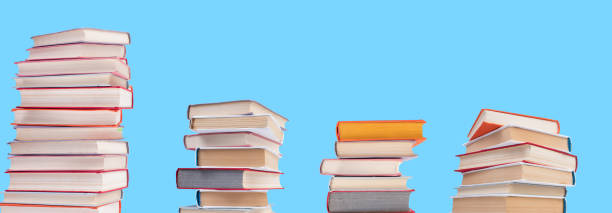 istock Composition with hardback books on wooden deck table and blue background. Books stacking. Back to school. Copy Space. Education background. panorama, banner. 1753952436