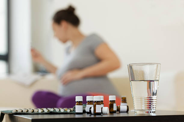 istock Pregnant Woman with Homeopathic Pills 175395338