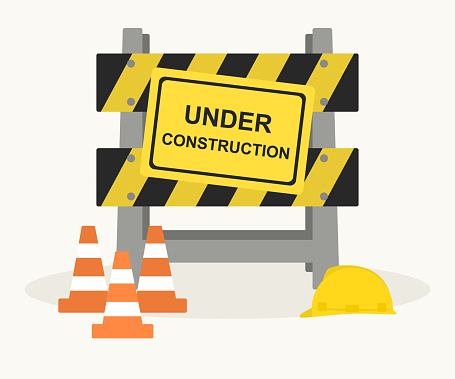Under Construction Barrier With Traffic Cones And Hard Hat. Warning Sign And Traffic Barricade