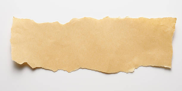 Torn piece of brown paper on white background Torn piece of brown wrapping paper isolated on white background. torn brown paper stock pictures, royalty-free photos & images