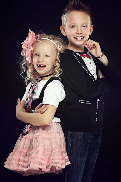 istock Cheerful girl and boy posing together laughing 175396525