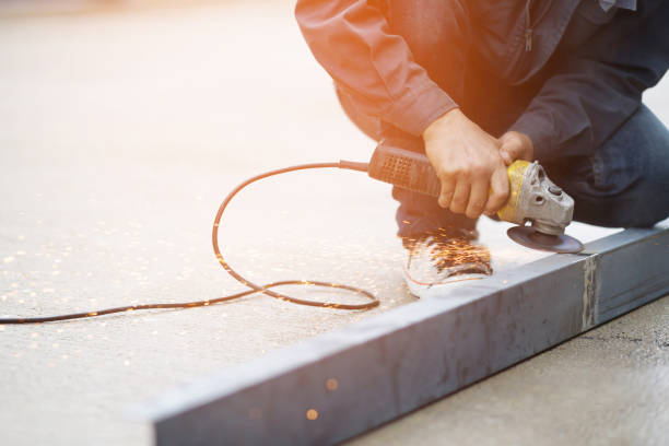 istock A worker cutting steel with a steel cutting machine sparked at a construction site. 1753967021