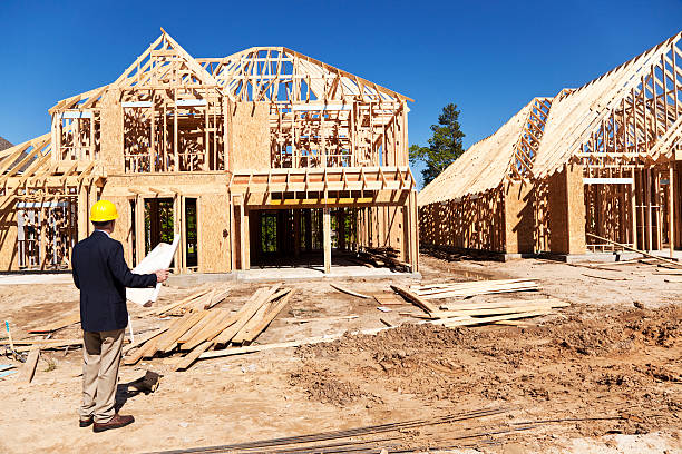 istock New home construction site with contractor in foreground 175397011