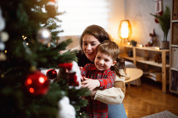 istock Mom and son decorating the Christmas tree together 1753970148
