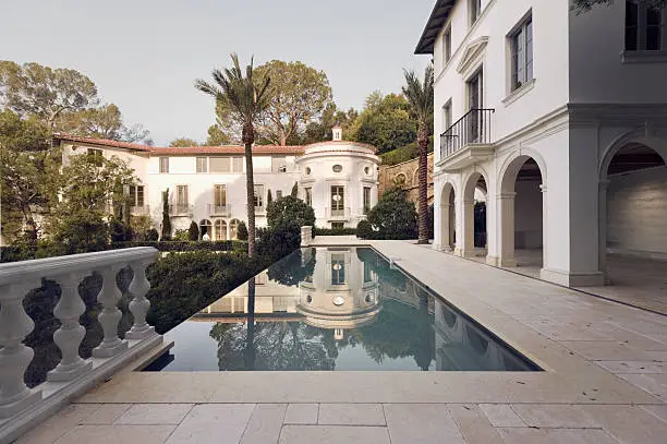 Early morning sunlight shines on a large estate home in Bel Air California.