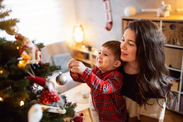 istock Mom and son decorating the Christmas tree together 1753972764