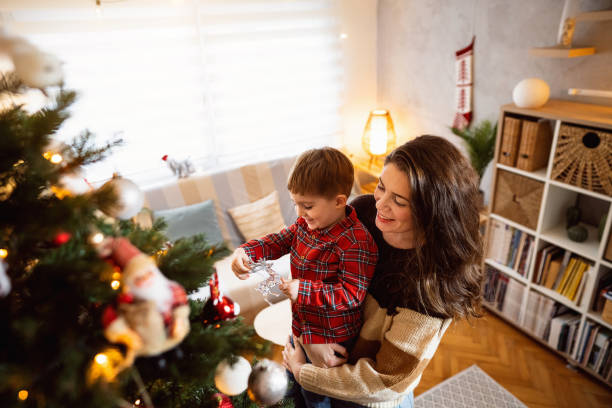 istock Mom and son decorating the Christmas tree together 1753972767