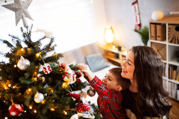 istock Mom and son decorating the Christmas tree together 1753972773