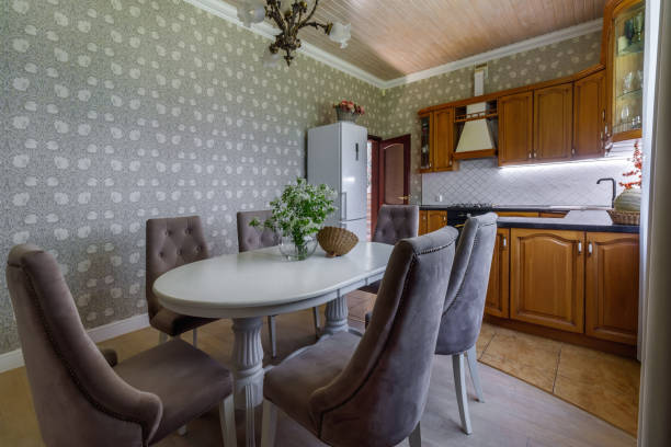 istock The interior of a modern light dining room with a long oval table surrounded by seats 1753973982