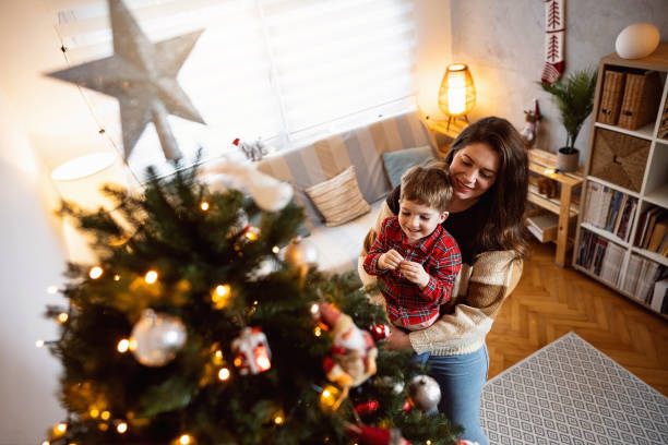 istock Mom and son decorating the Christmas tree together 1753975596