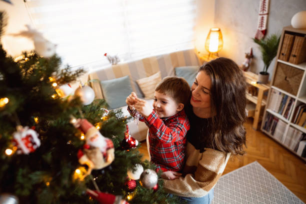 istock Mom and son decorating the Christmas tree together 1753975597