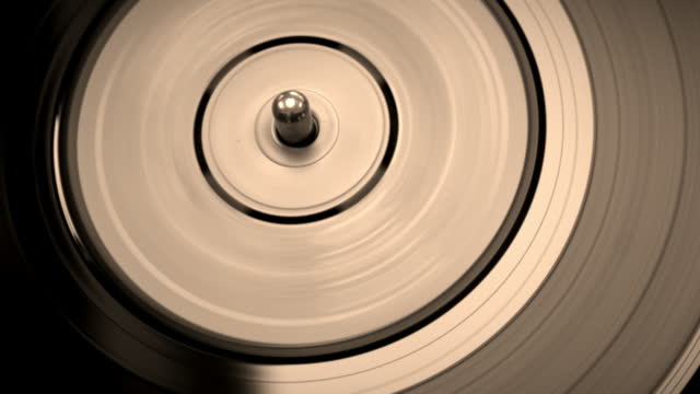 Retro desaturated 45 rpm single spinning on a turntable