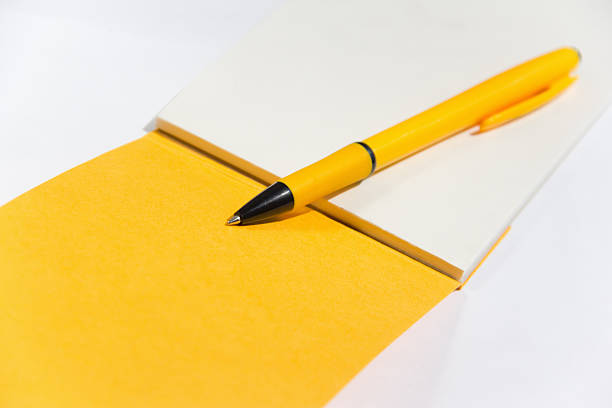 amarela caderno com uma caneta - workbook notebook pen ballpoint pen - fotografias e filmes do acervo