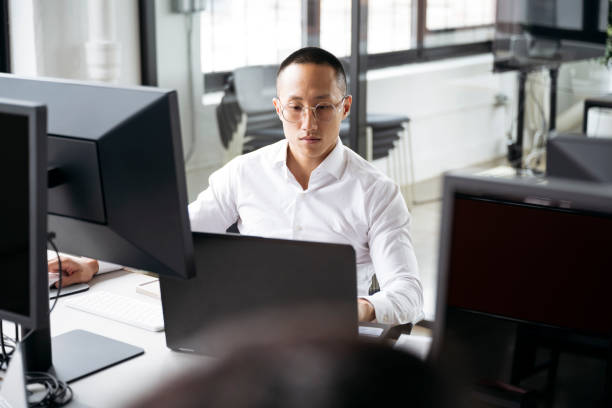 istock Taiwanese businessman using laptop in modern office 1753983144