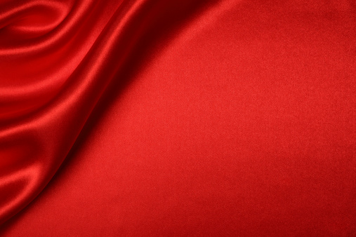 Red silk background with blank space.