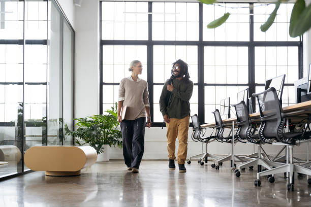 istock Business associates walking and talking in loft office 1753984292
