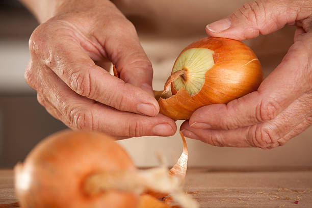 close up peeling onion stock photo