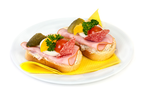 Two open sandwiches on plate. Ready to eat. Isolated on white background.