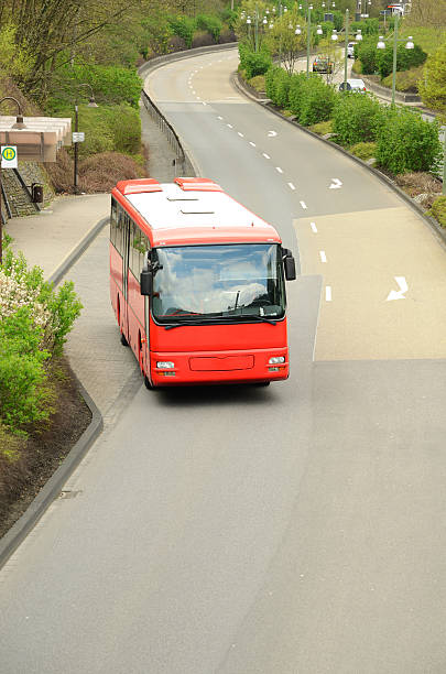 istock Red public bus pulls out of stop area into street 175398961