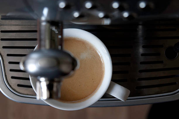 Espresso pouring into two cup