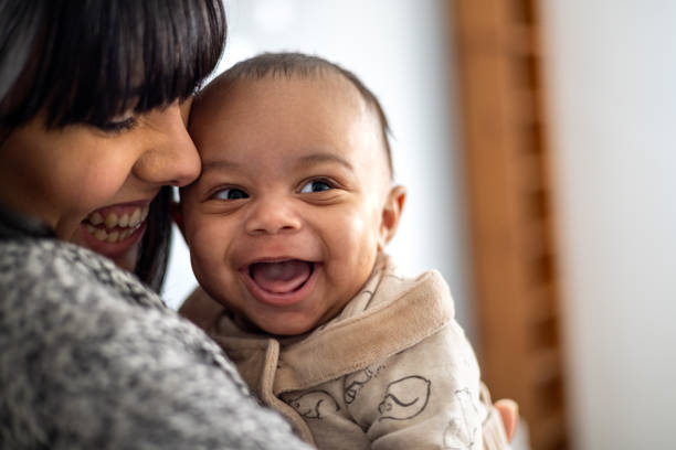 Snuggling in With Mum Close-up of a mother holding her baby boy near her face. The baby boy is laughing looking away from the camera making his mother laugh.
Video also available of this scenario. cute baby laughing stock pictures, royalty-free photos & images
