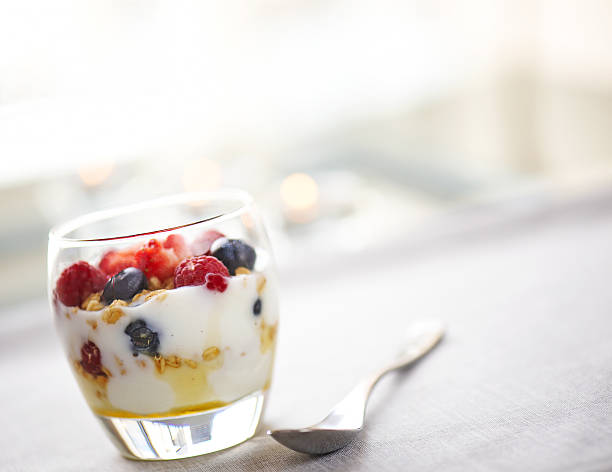 Nutritious glass of yougurt with honey and fruits stock photo