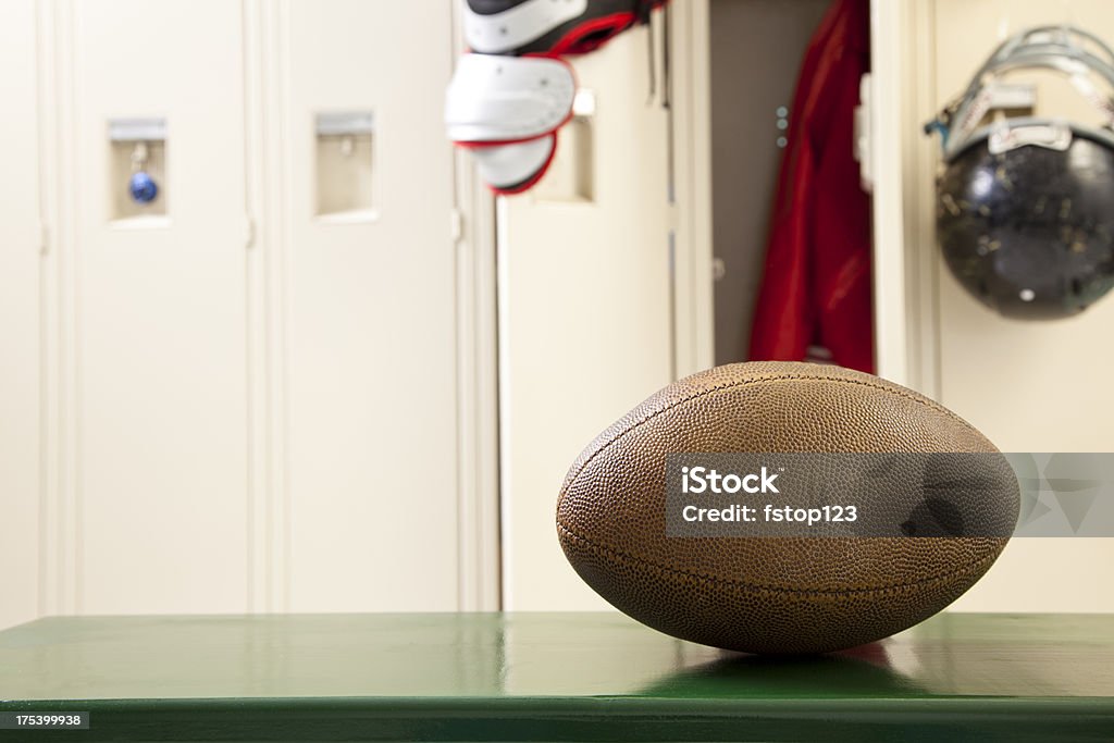 Football and helment on bench in locker room Football and helment on bench in locker room.  MORE LIKE THIS... in lightboxes below! Locker Room Stock Photo