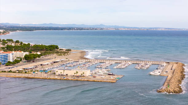 This aerial drone photo shows the town of L'Hospitalet de l'infant. The town with a beach and marina is located at the coastline of Catalonia, Spain.