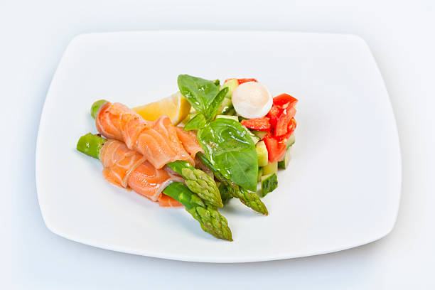 Green asparagus with salmon and vegetables on a plate