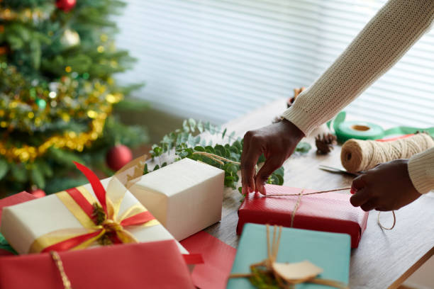 istock Woman Decorating Wrapped Gifts 1754004172