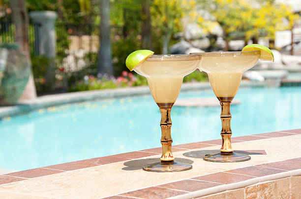 Two Margarita Drinks With Pool In Background stock photo