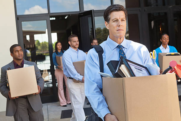 Group of professionals leaving office after layoff or being fired