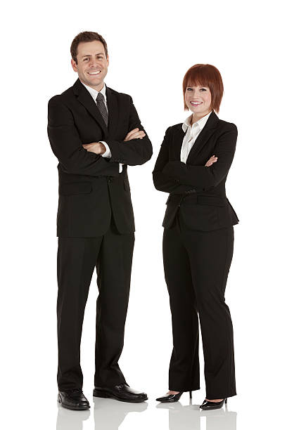 istock Smiling business couple standing with arms crossed 175400785