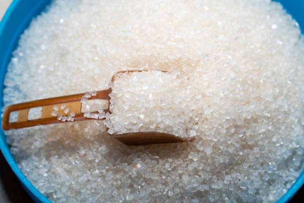 istock white sugar in spoon on wooden table background 1754008262